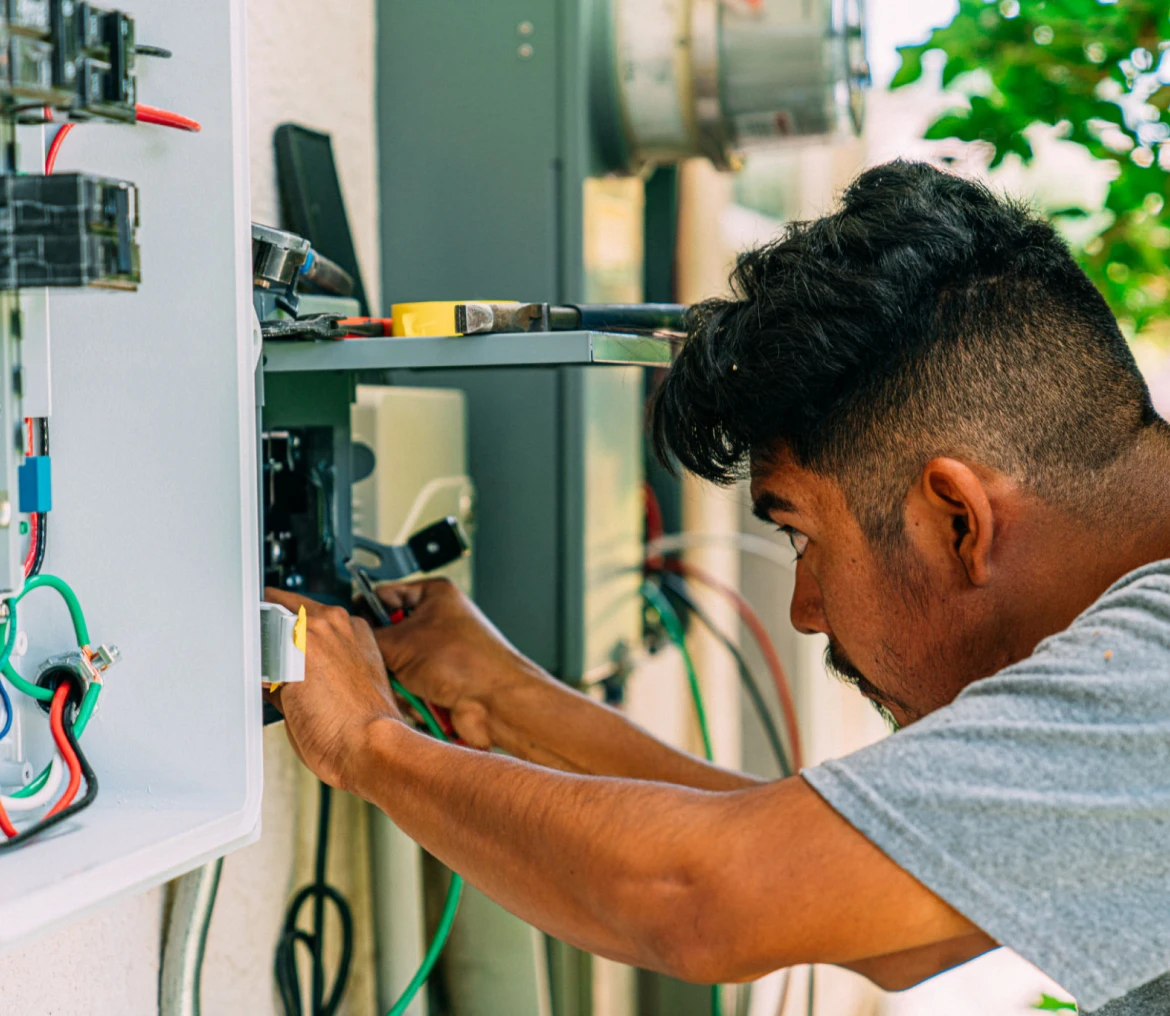 Technician fixing electrical wiring outdoors